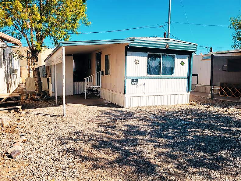 Single-wide home with covered carport